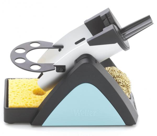 The image shows a soldering stand with a soldering tip, a sponge, and a brass cleaning brush. The stand has a triangular base and is designed in black and blue.