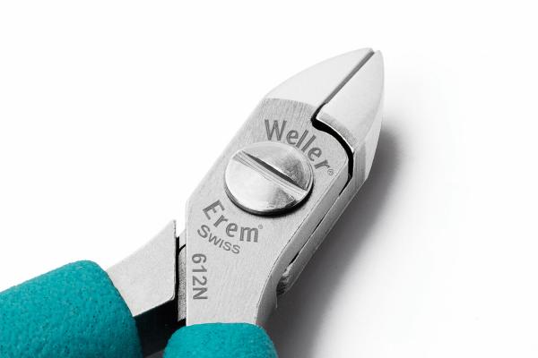 The image displays a high-quality pair of pliers with a shiny silver head and turquoise handles. Brand markings are engraved on the pliers.