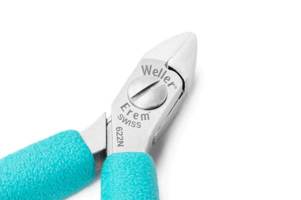 The image displays a pair of pliers with a shiny metallic head and non-slip, turquoise handles. The top is engraved with the brand "Weller" and some technical specifications.
