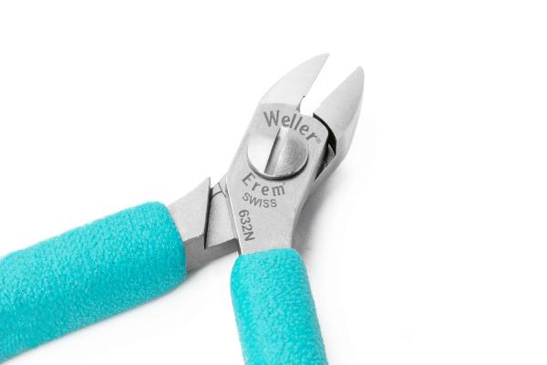 The image shows a silver pliers with pointed, sharp-edged blades and turquoise handles. It has a central, round screw for adjustment. It is suitable for fine work.