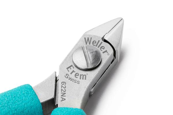 The image shows a compact pair of pliers with a silver metal surface and turquoise handles. The head of the pliers has a sharp tip and a screw for adjustment.
