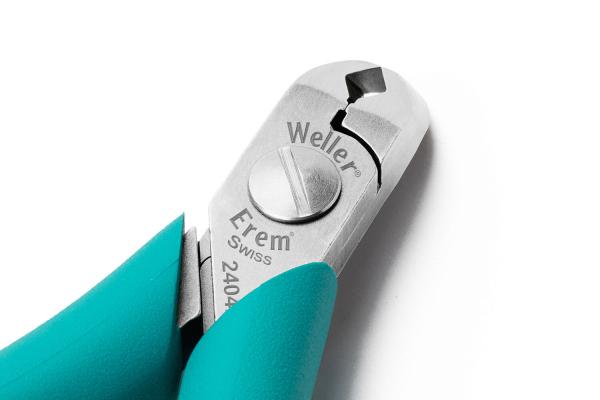 The image shows a pair of pliers with green, ergonomic handles and a silver cutting blade. The manufacturer's information is engraved on the blade. It appears sturdy and precise.