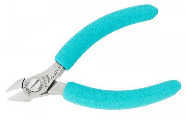 The image shows a small pair of pliers with light blue, grippy rubber coatings. The cutting surfaces are made of shiny metal, and the pliers have a precise, pointed shape.