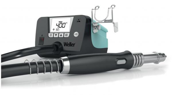 The image displays a soldering iron kit. It includes a digital control unit with a display and controls. Attached to a hose is the soldering tip.