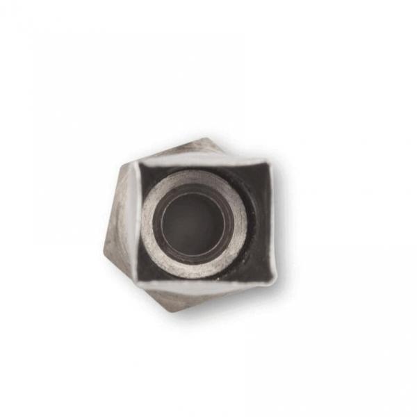 The image shows a hexagonal nut lying on a white background. The nut has a black recess in the center and appears to be made of metal.