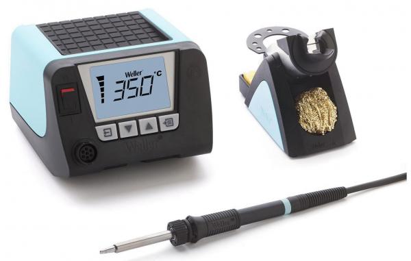 The image shows a soldering iron with a digital temperature display, a tool stand, and a cleaning device, all in black and blue. The soldering iron has a fine tip.