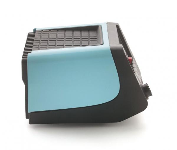 The image shows a compact device with a blue, rounded side and a black grid-like surface. It has a simple shape and could be some type of kitchen appliance or electronic equipment.