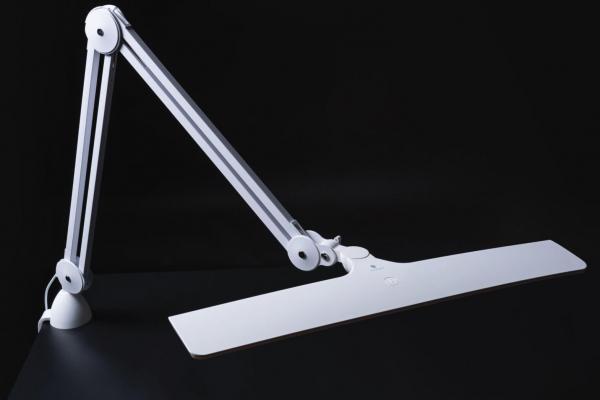 The image description shows a modern, white desk lamp with a long, flat light panel and a flexible arm attached to a sturdy base.