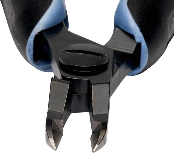 The image shows the tips of a side cutter. The blades are sharp and v-shaped, with a round swivel mechanism in the center. The handle is black with blue elements.
