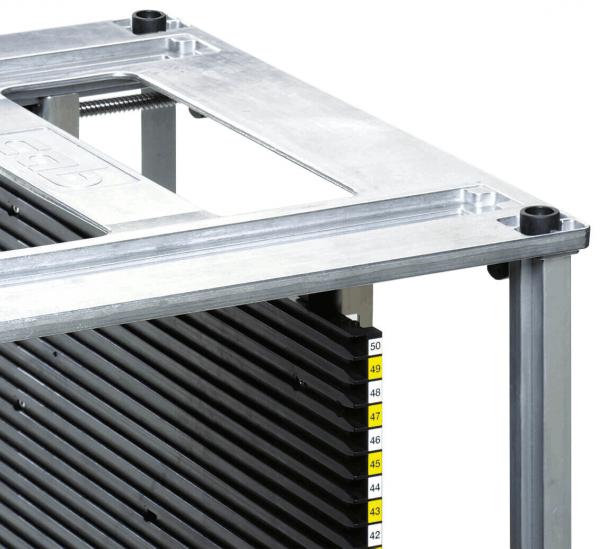 The image shows a large, rectangular metal frame with a transparent, flat top. Below it are vertical, black slats and numbered scales from 42 to 50.