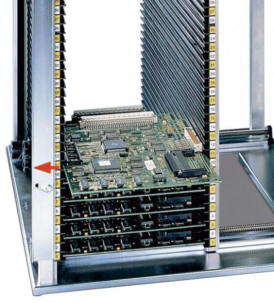 The image displays a vertical computer rack with multiple green-painted circuit boards. The boards are stacked in a metal casing, equipped with several connectors and slots.
