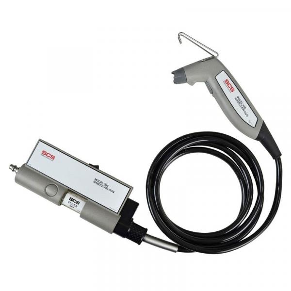 The image shows a device with a gray casing and a black application. It has a hose leading to a handle that has a small opening.