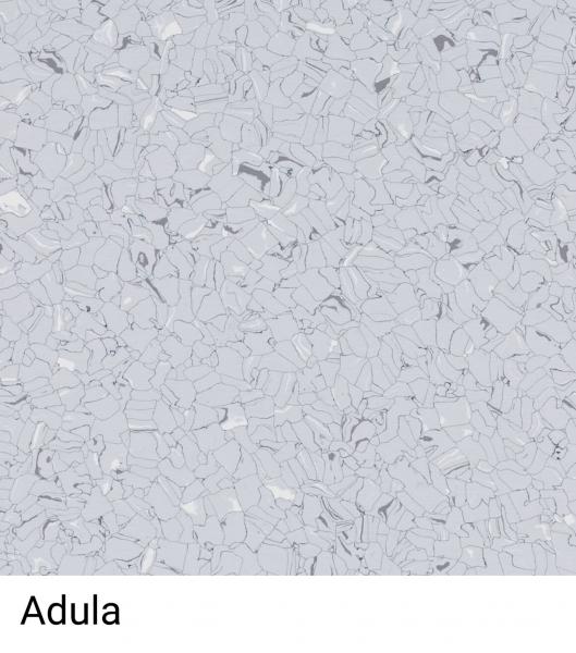 Das Bild zeigt eine helle, graue Oberfläche, die aus vielen kleinen, unregelmäßigen und glänzenden Teilchen besteht. Diese sind in verschiedenen Grautönen angeordnet. Unten steht "Adula".