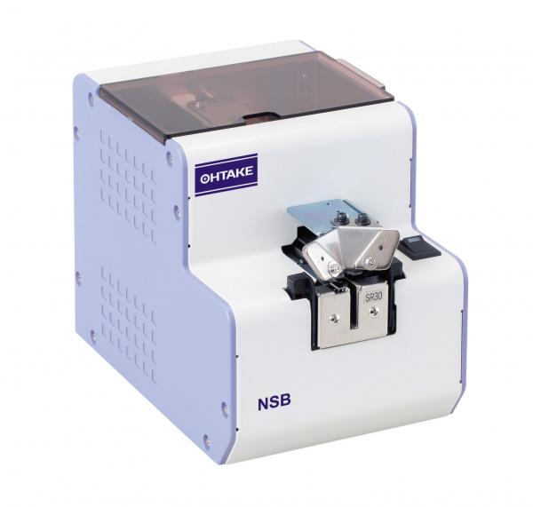The image displays a white device from OHTAKE. It features a square shape, a transparent cover on top, and a connection for practical use on the front.