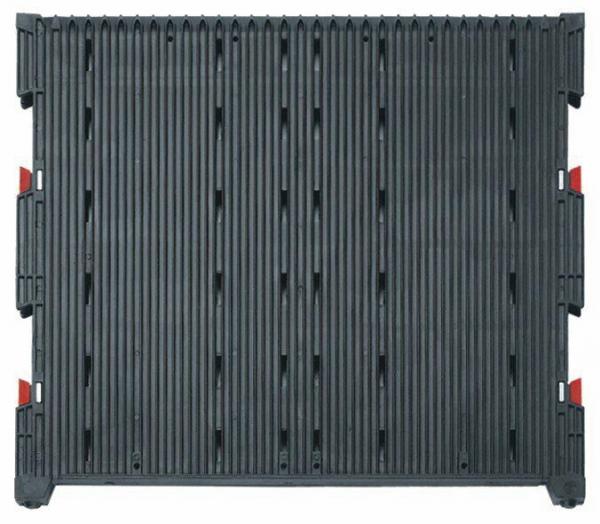 The image displays a rectangular, black plastic plate with vertical grooves. At the corners, there are red fasteners that stabilize the structure. It appears sturdy and functional.