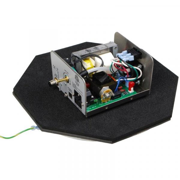 The image shows an electronic device on a hexagonal base. It consists of a casing with various cables and components, including a green circuit board and several connectors.