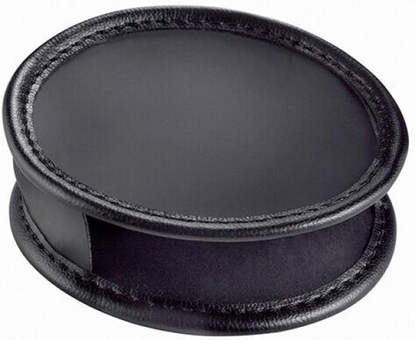 The image shows a round, flat object made of black material. It has a slightly raised edge and an opening on the side. The surface is smooth and shiny.