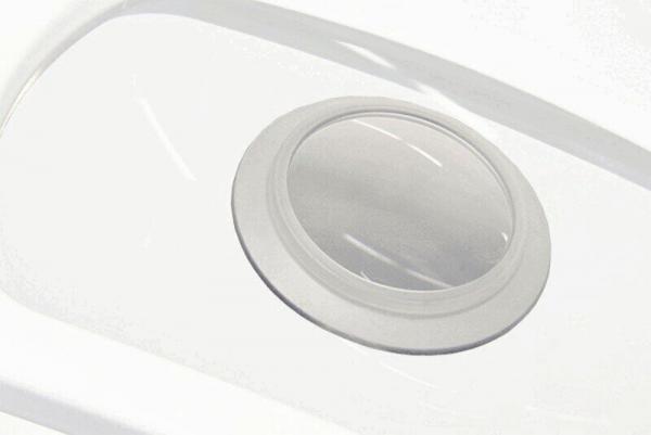 The image shows a round, circular opening in a white surface. The edge is slightly raised and smooth. The center is transparent and reveals the space underneath.