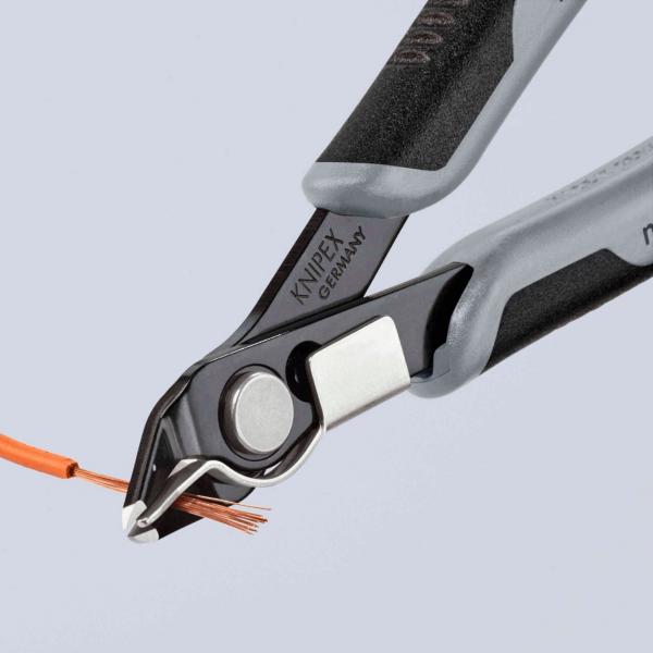 The image shows a pair of pliers with black and gray handles. The pliers are cutting an orange cable bundle. The cutting area is designed to be precise and sharp.