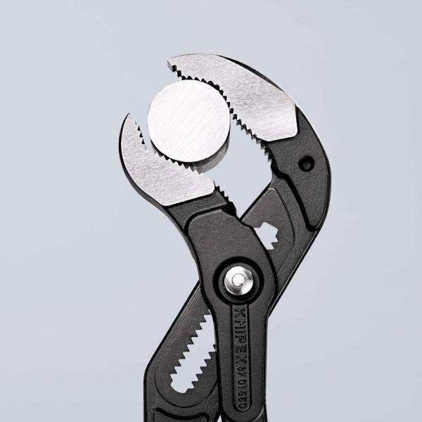 The image displays pliers with a round, smooth metal surface in the center. The plier handles are black and the pliers have serrated edges for better grip.
