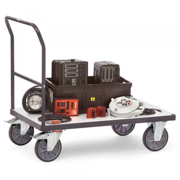 A flatbed truck with a handle and four wheels. On the surface, there is a black box, tool parts, several round objects, and a control unit. Everything is neatly arranged.