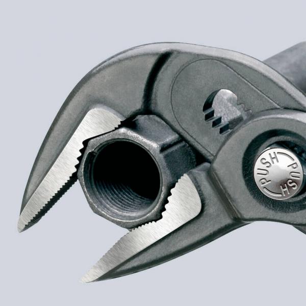 The image shows a pair of pliers with two movable jaws and a round opening. The pliers have a gray handle and a silver, round button labeled "PUSH".