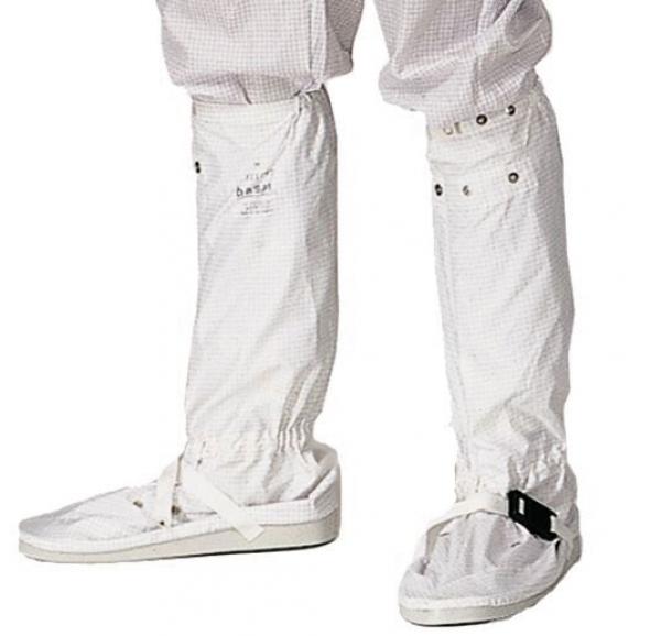 The image shows legs clad in white, slim-fit pants. The pants are secured at the ankle and feature an elastic band. The feet are in white, flat shoes with straps.
