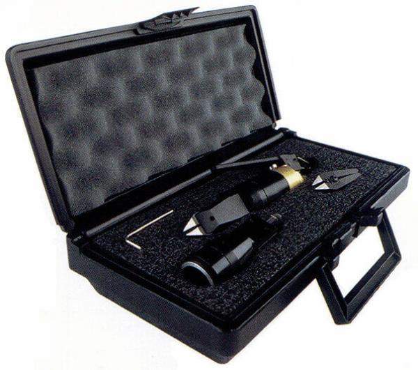 The image shows a black toolbox that is open. It contains several tools, including pliers and two other black objects, all on a foam-padded floor.
