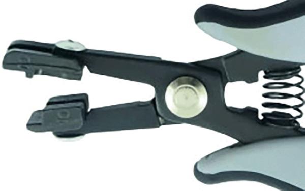 The image shows a black, ergonomically shaped pliers with gray handles. The pliers have a spring-loaded opening and two pointed gripping arms at the front, which can be moved together.