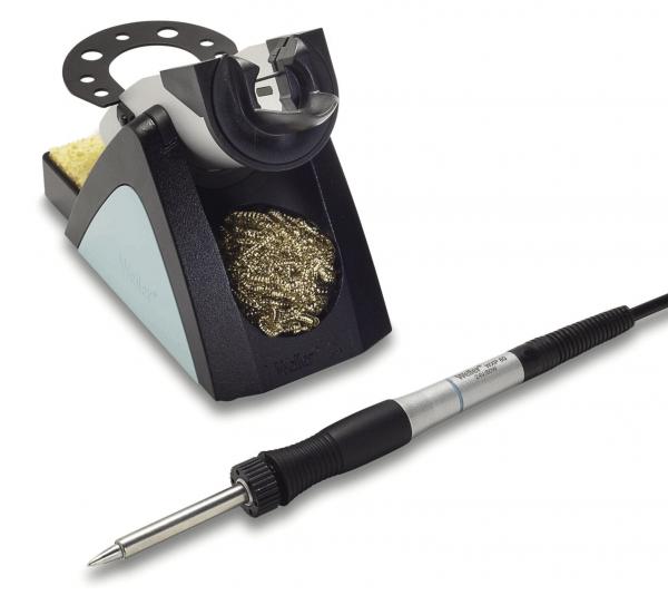 The image shows a soldering iron with a cable and a soldering iron stand. The stand is black with gray and metallic elements and includes a fine, metallic cleaning spiral.