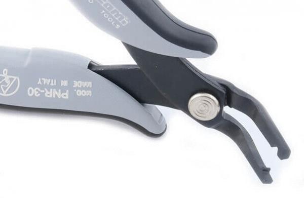 The image shows a gray pliers with two curved jaws. It has a round handle and a silver screw closure in the middle. The pliers are compact and handy.