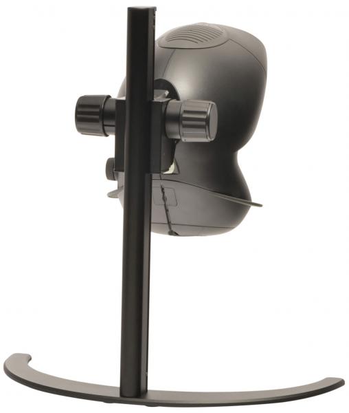 The image shows a black, round computer camera attached to a sturdy, vertical holder. The holder has a curved base. The camera lens faces forward.