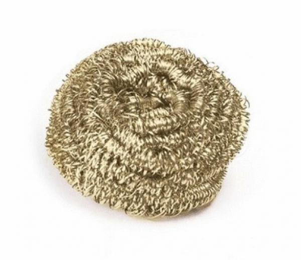 The image shows a golden, spiral-shaped metal grill brush. It appears like a small, firm cloud or a knitted ball of fine wires, shiny and textured.