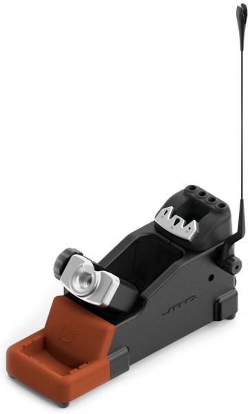 The image shows a black device with a wide base and a brown bottom. On top, there is a silver lens and several holes. A thin antenna is attached to the side.