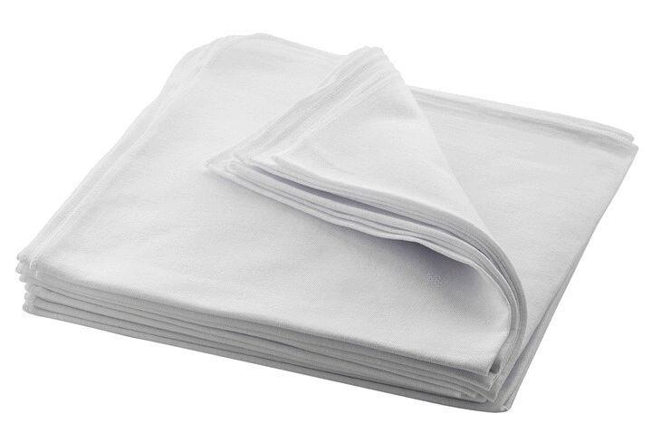The image displays multiple overlapping, folded white towels. The towels feature a soft, smooth texture and are neatly stacked. One towel is slightly unfolded.