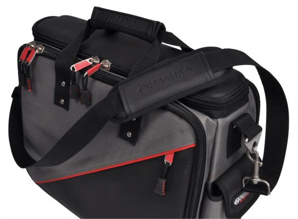 The image shows a gray bag with red accents. It has two handles, a detachable shoulder strap, and several pockets with zippers. The surface is durable.