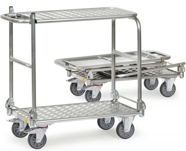 The image shows two portable aluminum stretchers. The larger one has two wire shelves, the smaller one a flat shelf. Both are mounted on four wheels and are stable and lightweight.