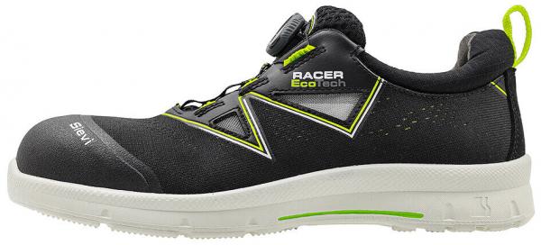 The shoe is black with bright green accents. It has a sporty design, a closed toe area, and a bright, non-slip sole. The closure is via a twist system.