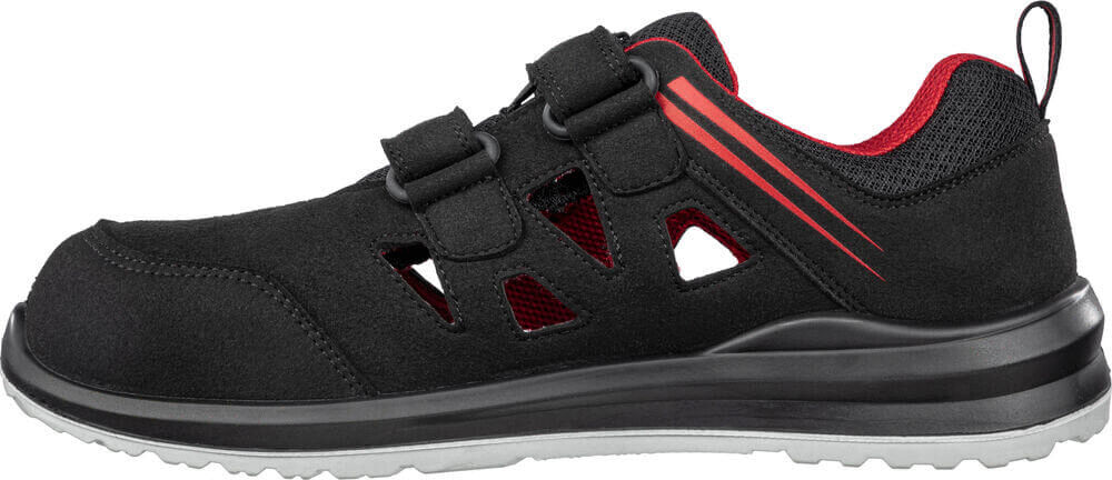 Das Bild zeigt einen schwarzen Schuh, der sportlich und modern wirkt. Er hat zwei Klettverschlüsse und seitliche Belüftungsöffnungen. Die Innenseite ist rot und die Sohle ist stabil und schwarz.