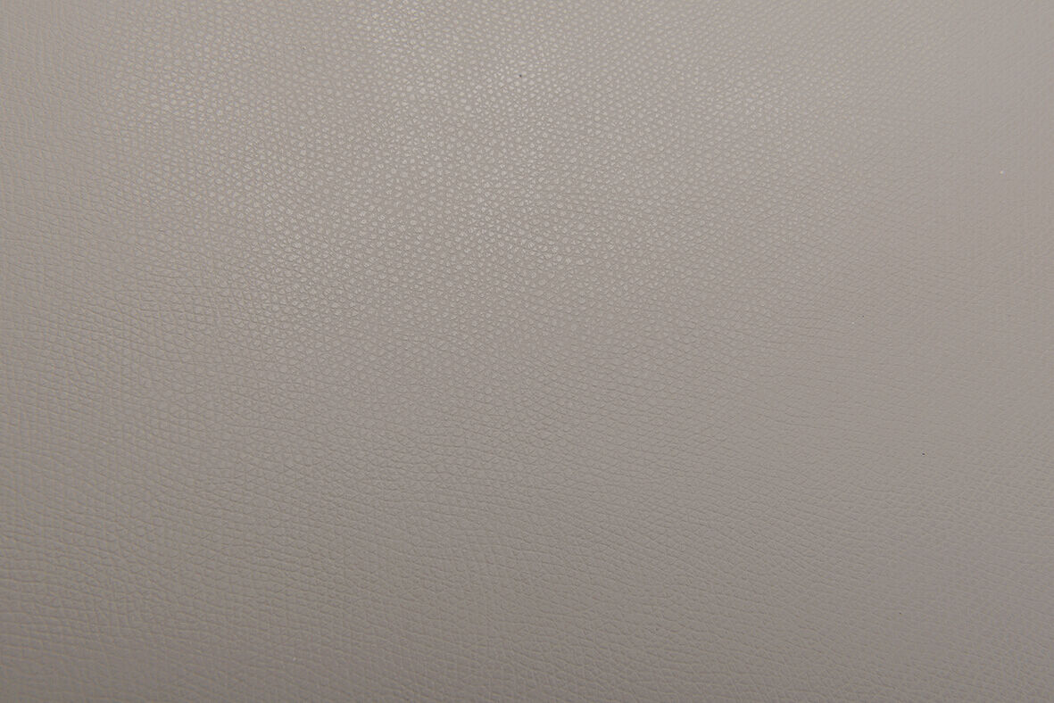 The image displays a monochrome, matte surface in shades of gray, without any discernible patterns or objects. It appears simple and neutral, almost like a blank sheet.