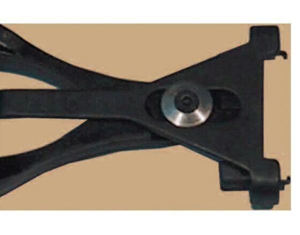The image shows a black tool with two long, curved handles connected to a sturdy plate with a round metal axis. It has a central opening.