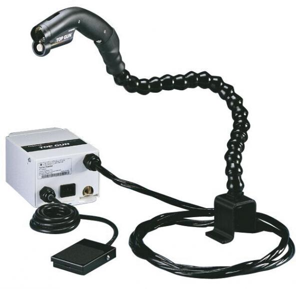 The image shows a technical device with a flexible, black arm and a control box. The arm has an ergonomic shape, and the box has multiple connection options. A foot pedal is also visible.