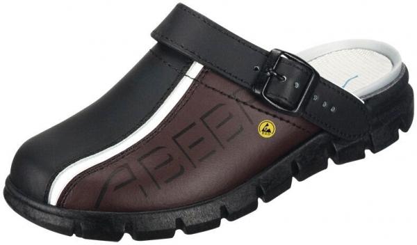 Der Schuh ist eine schwarze Clog mit einem braunen Lederoberteil. Er hat einen verstellbaren Riemen über dem Fuß und eine rutschfeste Gummisohle, die gut dämpft.