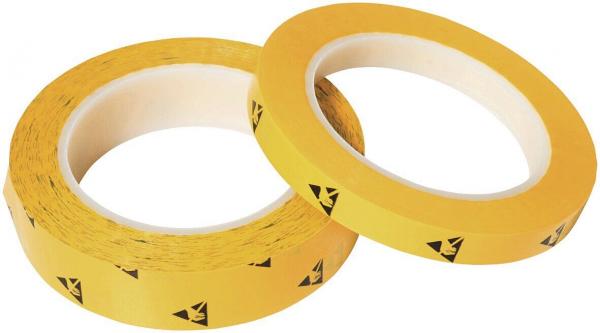 In the image, there are two rolls of yellow tape visible. The tape has black warning symbols indicating danger. The rolls have an inner core made of cardboard.