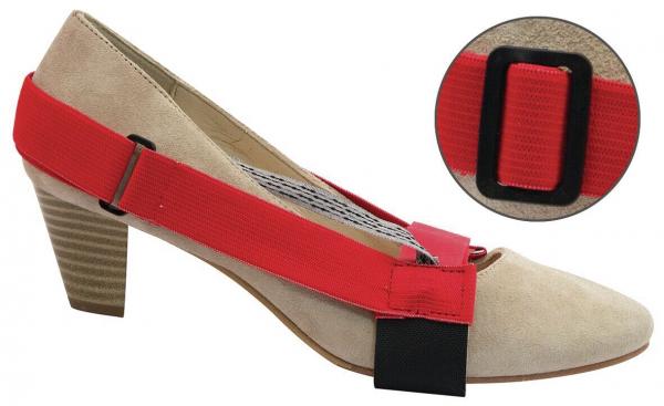 The image shows a beige high heel with a red elastic band stretched over the forefoot. A black holder is visible under the shoe. A smaller section shows the elastic band in closer detail.