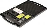 Preview: The image shows an open, black-foaming suitcase. Inside, there are various devices and accessories, including a digital display, cables, and other technical components.