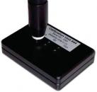 Preview: The image shows a black calibration device with a vertical, cylindrical column. On the surface, there is a label that reads 