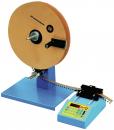 Preview: The image shows a physical experiment apparatus. It has a large, round wooden wheel on a stable blue base, with a digital display and buttons for control.