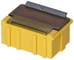 Preview: The image shows a yellow box with a transparent top. It has a rectangular shape and three vertical grooves on the sides. A metal part is visible on top.