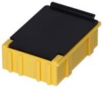 Preview: The image shows a small, rectangular container. It has a yellow bottom with grooves and a black lid. The lid is flat and has a slight overhang.